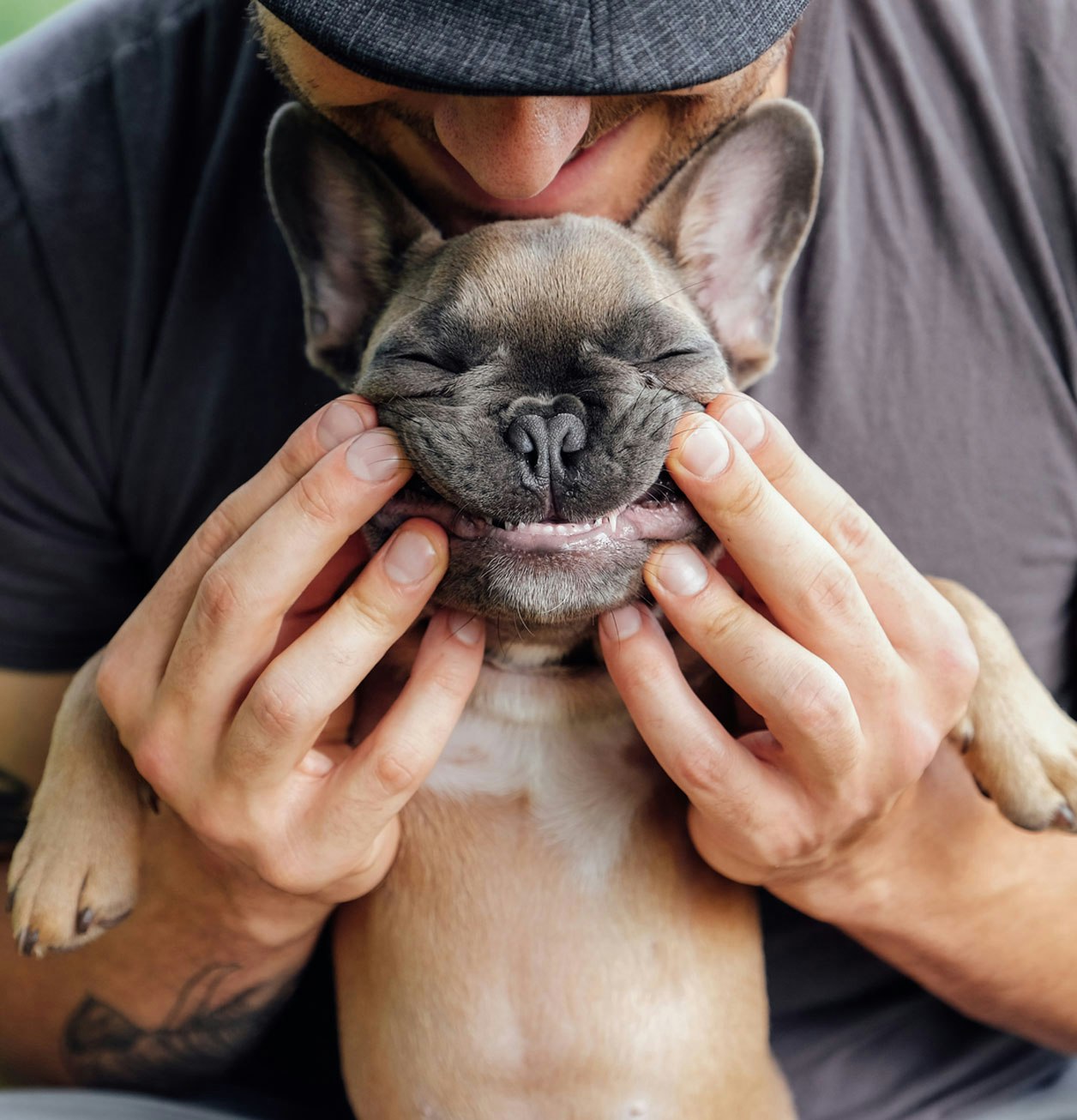 Man holding up smiling puppy “